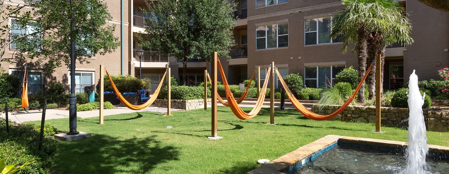 Outdoor turf with hammocks, a fountain, and nearness to pool