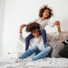 lifestyle image of a mother and child playing in a bedroom